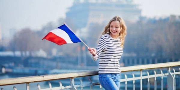 A French female young adult waving a French flag